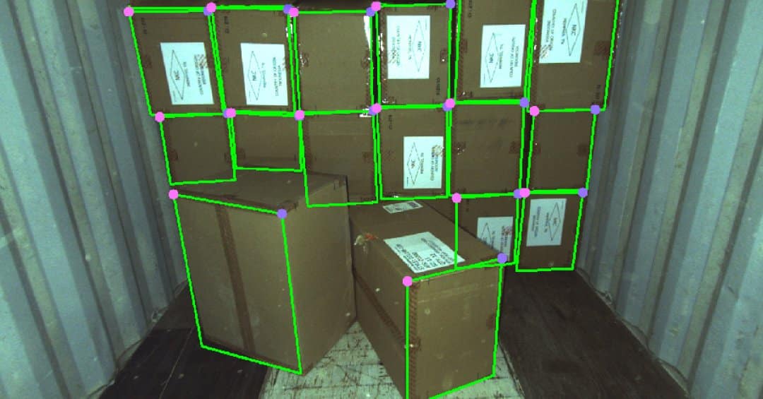 Cardboard cases in a trailer overlaid by computer vision bounding boxes.