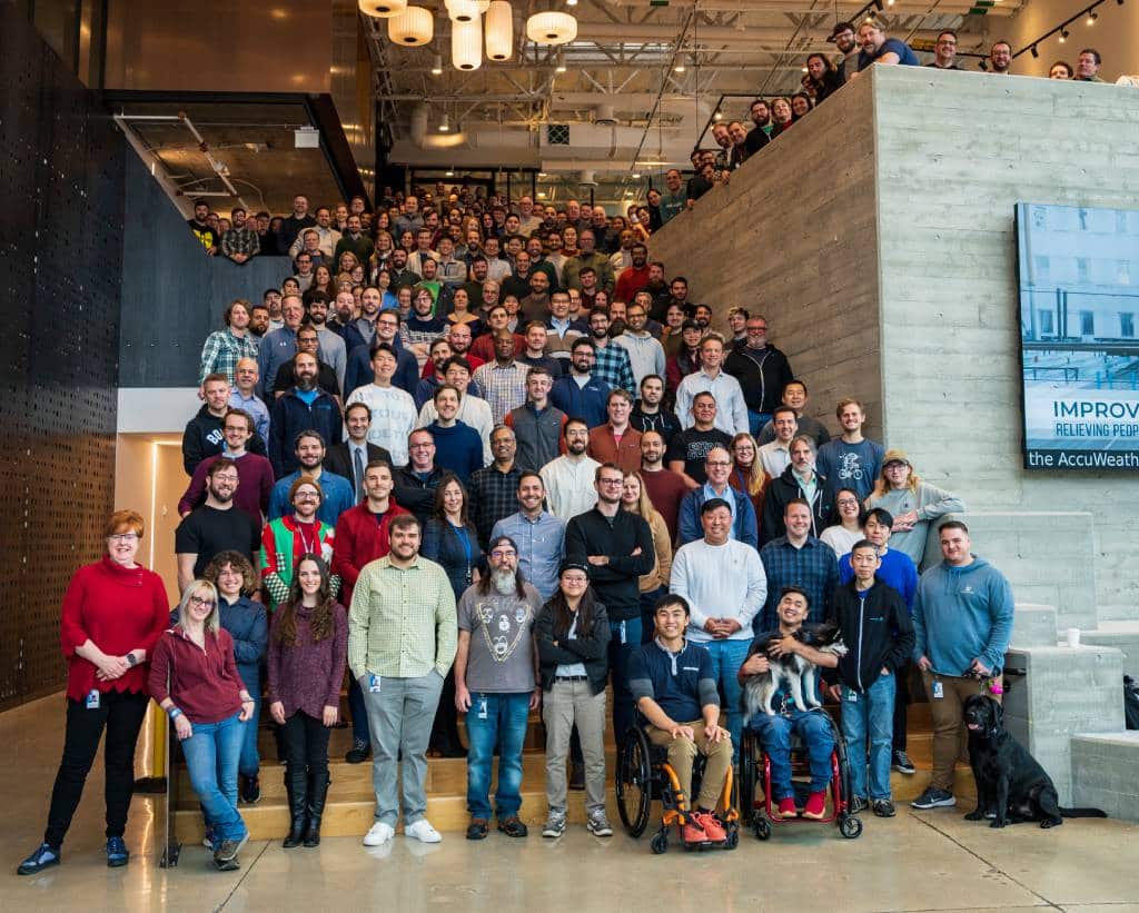 A group photo of team members filling the stairs at the Boston Dynamics headquarters