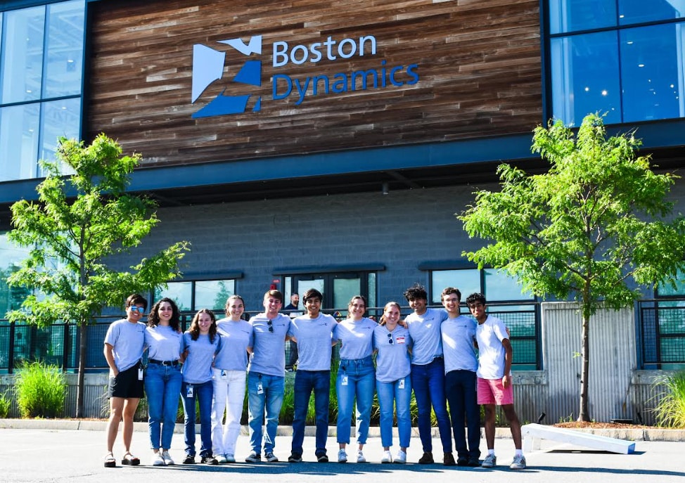 A group of interns pose in front of the Boston Dynamics headquarters