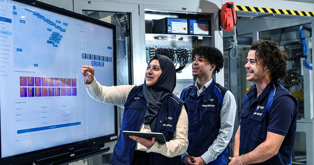 3 engineers review thermal inspection data on a monitor 