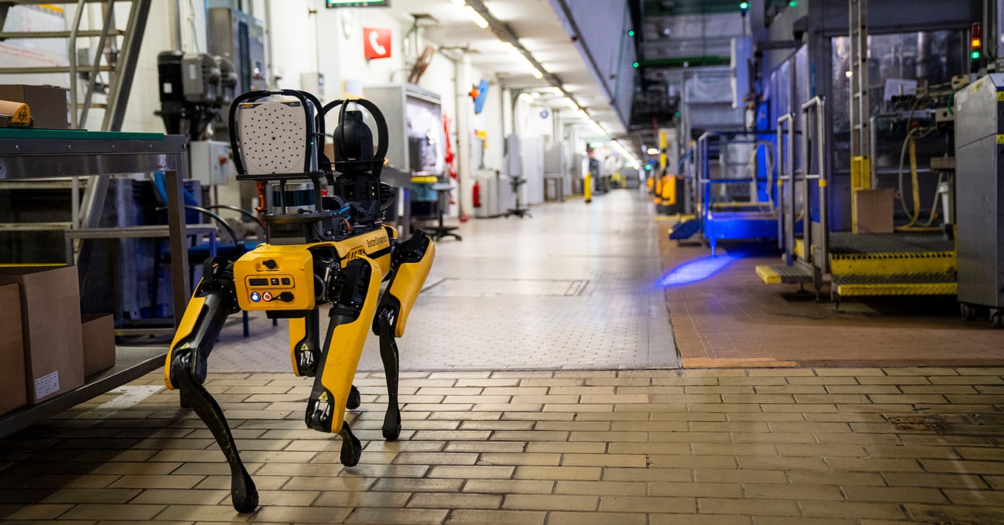 Spot walks through a food and beverage factory equipped for industrial inspection