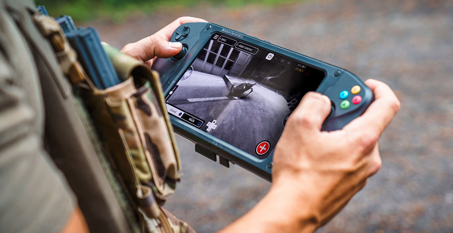 An operator uses the Spot Tablet Controller Pro to inspect a suspicious package