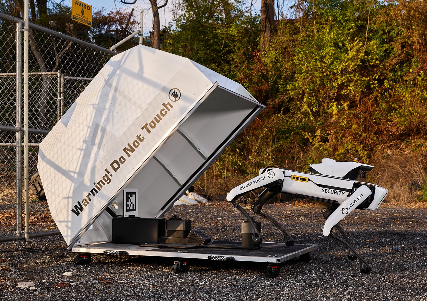 Spot, equipped with the Asylon security sensors, steps out of a robot shelter