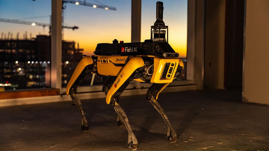 Spot robot in a building under construction with a sunset in the background