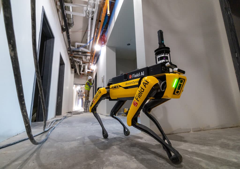 Spot robot with FieldAI payloads on a construction site