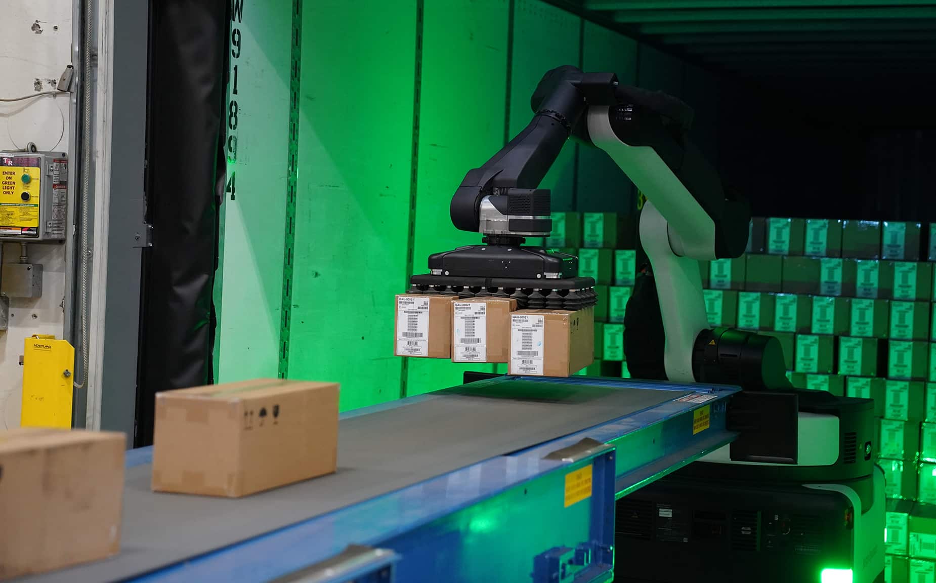 Stretch robot unloads three boxes simultaneously from a trailer